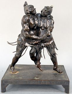 Japanese Bronze Figural Group, two sumo wrestlers fighting, each struggling wearing fringed kesho-mawashi standing on bronze low table plinth, unsigne