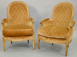 Pair of Louis XVI Beechwood Bergeres, 18th century, dished back with molded arched top rail, on round tapered and fluted legs covered in beige silk da