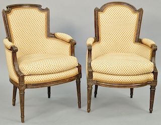A Matched Pair of Louis XVI Walnut Bergeres, late 18th century, round back on round tapered fluted legs, height 39 inches, width 26 1/2 inches, depth 