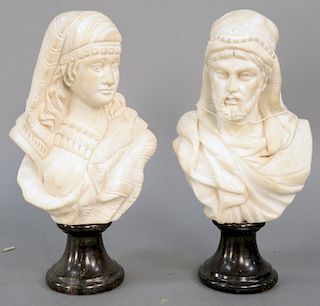 Pair of Italian Marble Busts, each white marble, bearded man and a woman partially clad wearing headdress, on conforming black granite socles. height 
