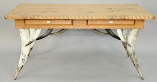 Milo Marks Desk, having steer horn legs and skirt, two drawers with antler handles and rope carved edge top. height 30 1/2 inches, top: 32" x 64 1/2".