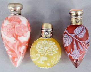 Three Webb Cameo Glass Perfume, pillow shaped, yellow ground with white lily pad and dragonfly, two red and white floral perfume, all with silver tops