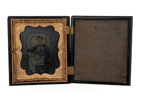 Portrait of a Gentleman. Ca. 1870. Ambrotype, 3.1 x 2.7" (8 x 7 cm.), details colored in gold. In case, with brass frames.