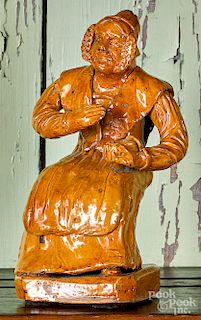 Redware figure of a seated woman