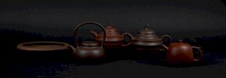 Grouping of Four Yixing Teapots and a Shallow Dish