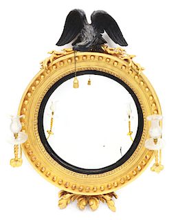 FINE CLASSICAL EBONIZED AND GILTWOOD DOUBLE-LIGHT CONVEX WALL MIRROR. FIRST QUARTER 19TH CENTURY.