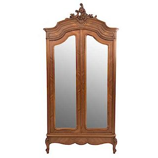 Armario. Francia. Siglo XX. En talla de madera de nogal. Con 2 puertas con espejos de luna biselada. 245 x 122 x 50 cm.