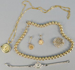 Gold lot, to include gold beads, two watches, one pin, one chain, pair of two Peso Mexican gold earrings. gross weight with watches 76.9 total grams.