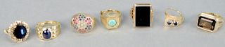 Six gold rings with stones, one with blue stone and small diamonds. 38.7 total grams.