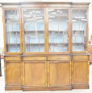 George IV style mahogany breakfront in two parts with four glazed doors on base with four drawers and four doors. ht. 96 in., wd. 98 in..
