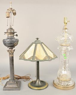Three table lamps, to include a Victorian silver plated oil lamp with columnar shaft electrified, a cut glass lamp, and a Bradley & Hubbard slag glass
