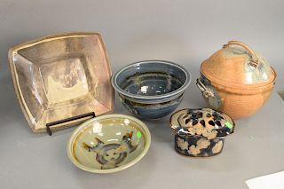 Group of six ceramic glazed pieces, to include two bowls signed on bottom, covered pot, covered jar, square charger 14" x 14".