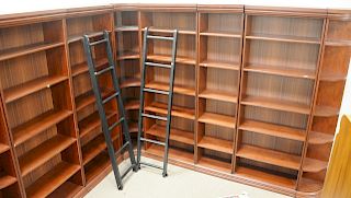 Eight section bookcases, with ladders, ht. 83 1/2 in., 14 1/2 feet of shelving.