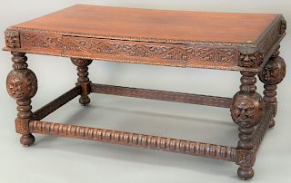 Victorian oak library table, having carved edges and lion faces on four sides and drawer on two sides, ht. 31 in., top 39" x 59".
