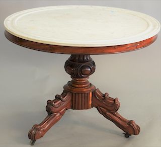 Victorian mahogany round center table having white marble top on pedestal, ending in tripod with base and claw feet, top 38 in..