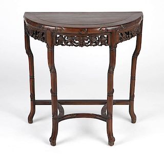 A Chinese carved teak demilune table