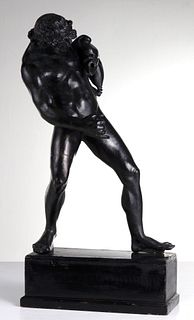 AN EARLY 20TH CENTURY BRONZE FAUN WITH WINE BAG