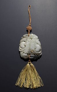 A CHINESE GREY AND CELADON CARVED JADE PLAQUE