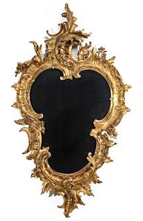 AN EARLY 20TH CENTURY GILDED CARTOUCHE FORM MIRROR