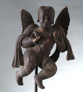 A PRIMITIVE WOOD CARVING OF AN ANGEL