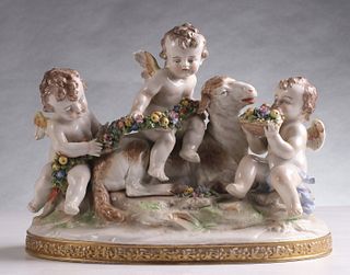 A CONTINENTAL PORCELAIN PUTTI AND LAMB GROUPING C. 1900