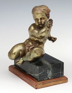 A CAST AND PINNED BRONZE PUTTO FIGURE ON MARBLE