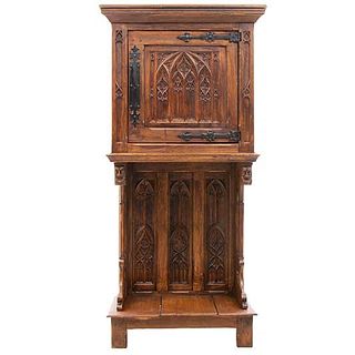 Credenza. France. 20th Century. Gothic Style. Carved in oak. Folding door and inferior shelf. 57 x 27.5 x 16.5" (145 x 70 x 42 cm.)