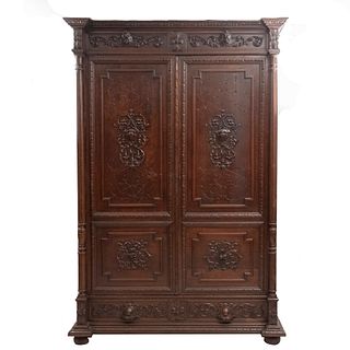 Wardrobe. France. 20th Century. Henri II. Carved in oak. Drawer with handle and two doors. 101.5 x 68 x 31.4" (258 x 173 x 80 cm).