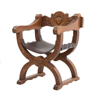 Curule Seat. France. 20th Century. Carved in oak. Semi-open backrest, seat in maroon-colored leather.