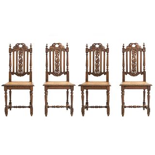 Lot of 4 chairs. France. 20th Century. Henri II. Carved in oak. Semi-open backrests y seats in bejuco.