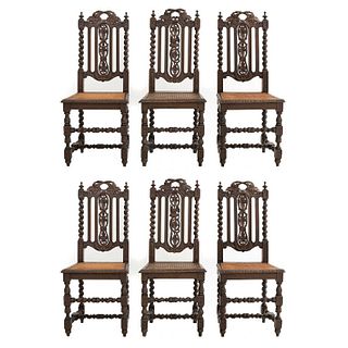 Lot of 6 chairs. France. 20th Century. Carved in oak. With semi-open backrests and seats made with bejuco.