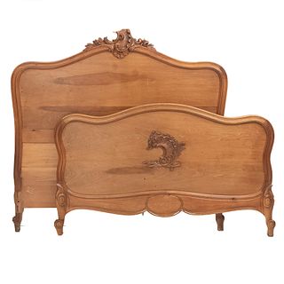 Double bed. France. 20th Century. Louis XV. Carved in walnut. Headboard, footboard, and 2 stringers.