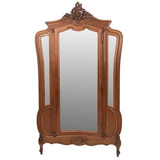 Wardrobe. France. 20th Century. Louis XV. Carved in walnut. Moveable door with mirror, beveled glass. 97.6 x 56 x 17.3" (248 x 143 x 44 cm)