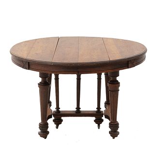 Table. France. 20th Century. Carved in oak. Circular tabletop and extendable system. 28 x 44 x 39.7"  (71 x 112 x 101 cm)