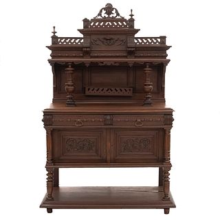 Cabinet. France. 20th Century. Henri II. Carved in walnut. Shelves, 2 drawers, 2 doors. 75.5 x 46 x 18.5" (192 x 117 x 47 cm)