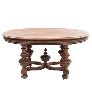 Table. France. 20th Century. Henri II. Carved in walnut. Oval tabletop and expandable system. 28.7 x 59 x 48" (73 x 150 x 122 cm)
