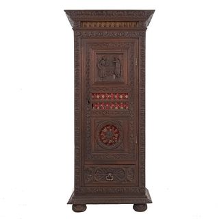 Wardrobe. France. 20th Century. Breton Style. Carved in oak. Hinged door and drawer with metal handle. 67 x 30.3 x 18.5" (171 x 77 x 47 cm)
