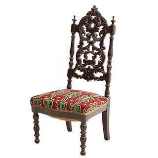 Chair. France. 20th Century. Carved in oak. Semi-closed backrest and seat upholstered in geometrically patterned cloth.