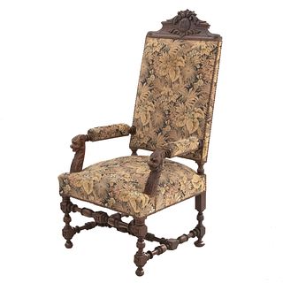 Armchair. France. 20th Century. Carved in oak. With closed backrest and seat upholstered in plant-themed cloth.