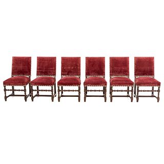 Lot of 6 chairs. France. 20th Century. Louis XIII. Carved in oak. With closed backrests and seats upholstered in wine-colored cloth.