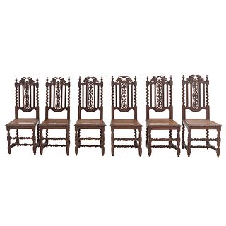 Lot of 6 chairs. France. 20th Century. Carved in oak. Semi-open backrestsand seats in bejuco.