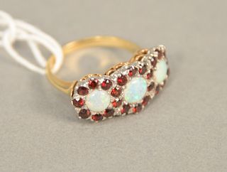 14K gold ring set with three opals each surrounded by red stones, size 6.