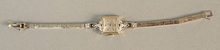 Longines 14K white gold ladies wristwatch set with four diamonds. total weight 14.9 grams.