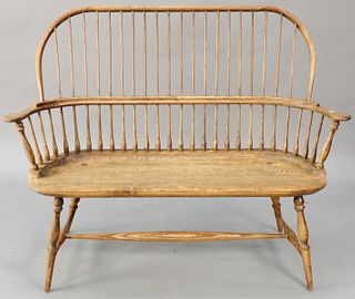 Oak Windsor style bow back bench (slightly loose)(fine split in seat, right side). ht. 42 in., wd. 56 in. Provenance: Former home of Mel Gibson, Old M