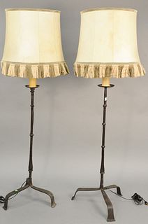 Pair of iron candlestick style floor lamps with faux candle sticks. ht. 68 in. Provenance: Former home of Mel Gibson, Old Mill Rd, Greenwich, CT