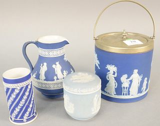 Group of four blue and white Wedgwood Jasperware to include biscuit jar, creamer and covered sugar and a cup. creamer ht. 5 1/2 in. Provenance: Former