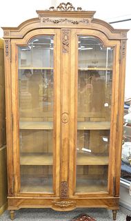 Louis XVI style two door display cabinet with beveled glass doors. ht. 97 in., wd. 53 in. Provenance: The Estate of Ed Brenner, Short Hills N.J.