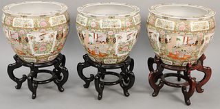 Three large Rose Medallion porcelain urns on stands. ht. with stand 25 1/2 in., ht. without stand 15 1/2 in.