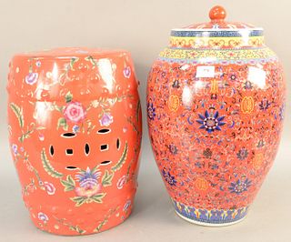Two Oriental porcelain pieces, red garden seat and a large porcelain urn with cover both painted with flowers. garden seat ht. 18 in., urn ht. 22 in. 