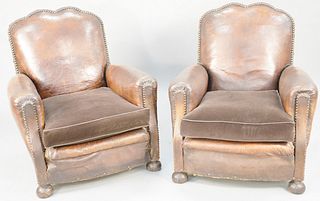 Pair of leather upholstered arm chairs with brass tacks and cloth cushions, (seat corners of leather is seperated). ht. 35 1/2 in., wd. 32 in. Provena